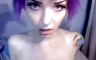 Gorgeous violet haired hottie with big tits holds a big dildo